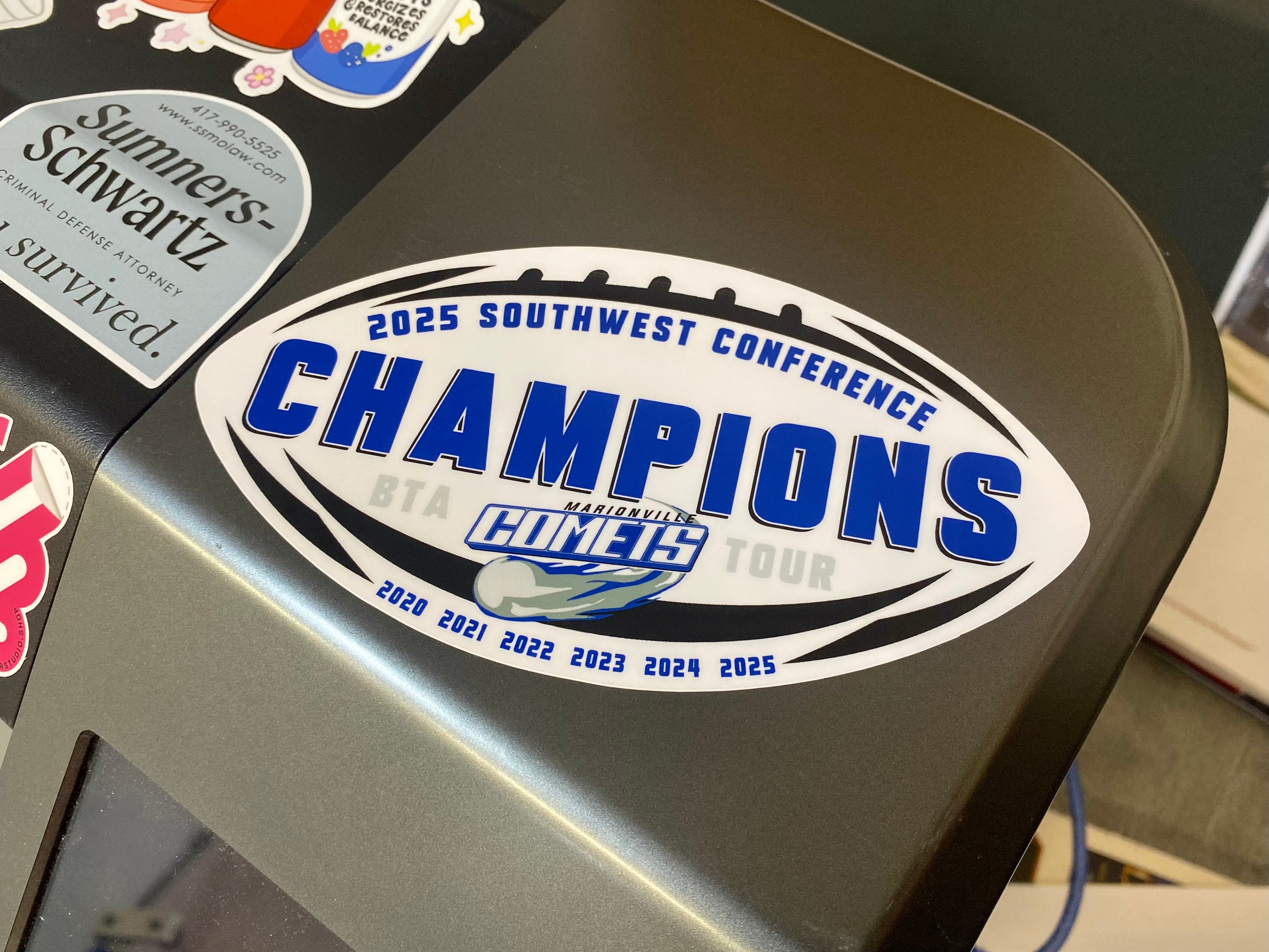 Sticker on a vehicle's windshield declaring '2025 Southwest Conference Champions' with multiple years listed.